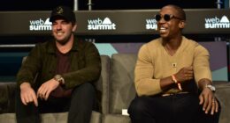 Two speakers seated at a conference.